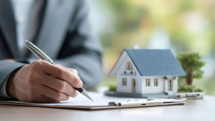 Real estate agent presenting sample home and mortgage contract to customer